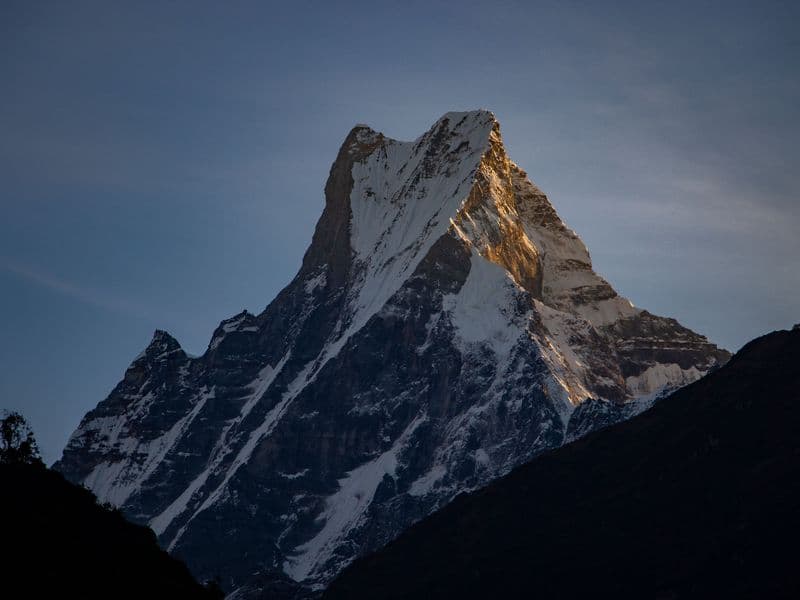Breathtaking view of the snowy peak of Machapuchare in the Himalayas at sunrise.