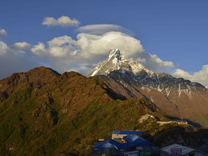 Stunning landscape of Machapuchare peak in Nepal's Himalayas at sunset.