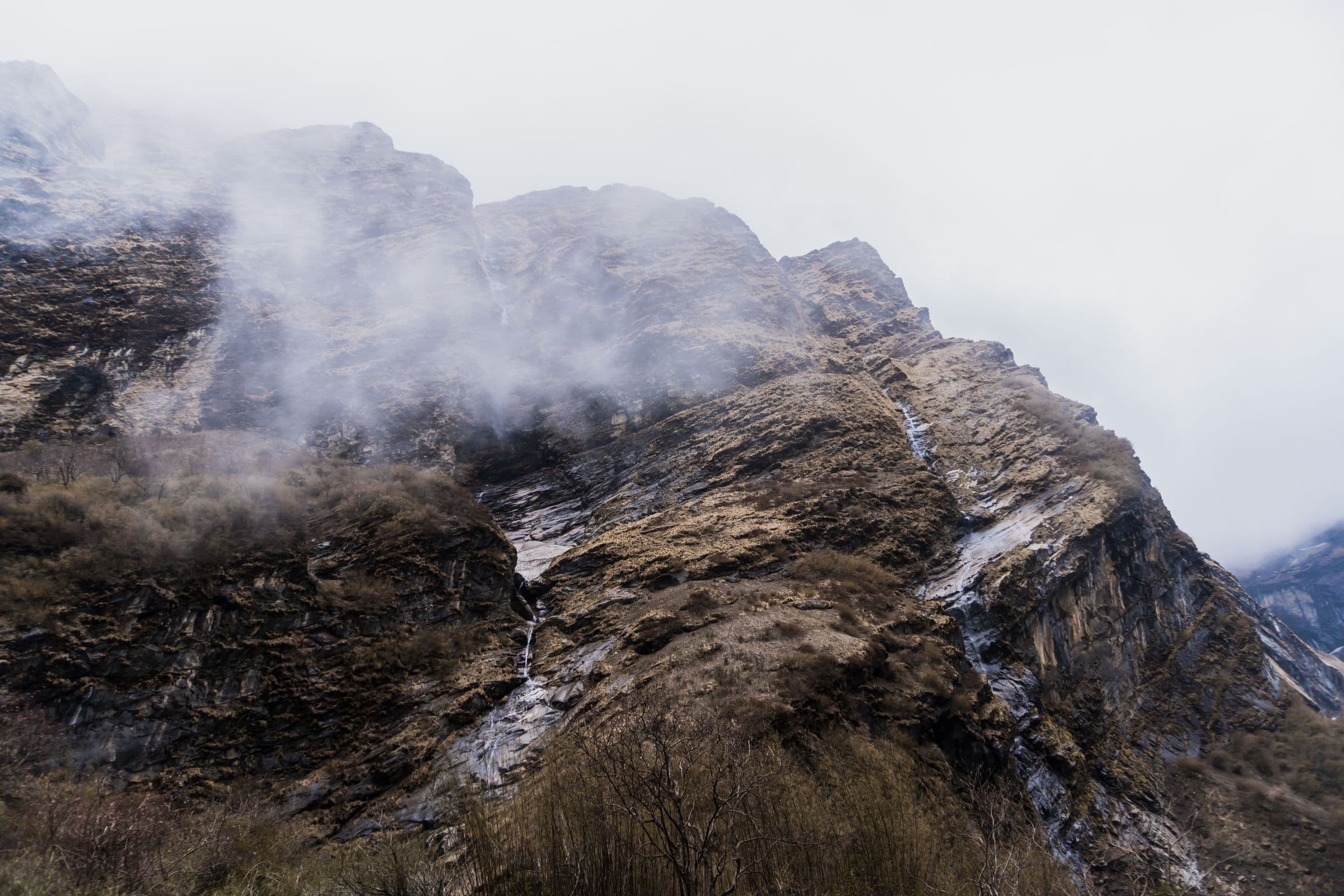 Captivating view of mist-covered mountains in Ghandruk, showcasing natural beauty and tranquility.