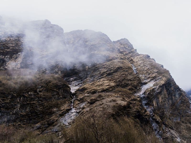 Captivating view of mist-covered mountains in Ghandruk, showcasing natural beauty and tranquility.