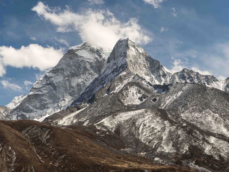 Stunning view of Mount Ama Dablam in the Himalayas with snow-covered peaks under a clear blue sky.