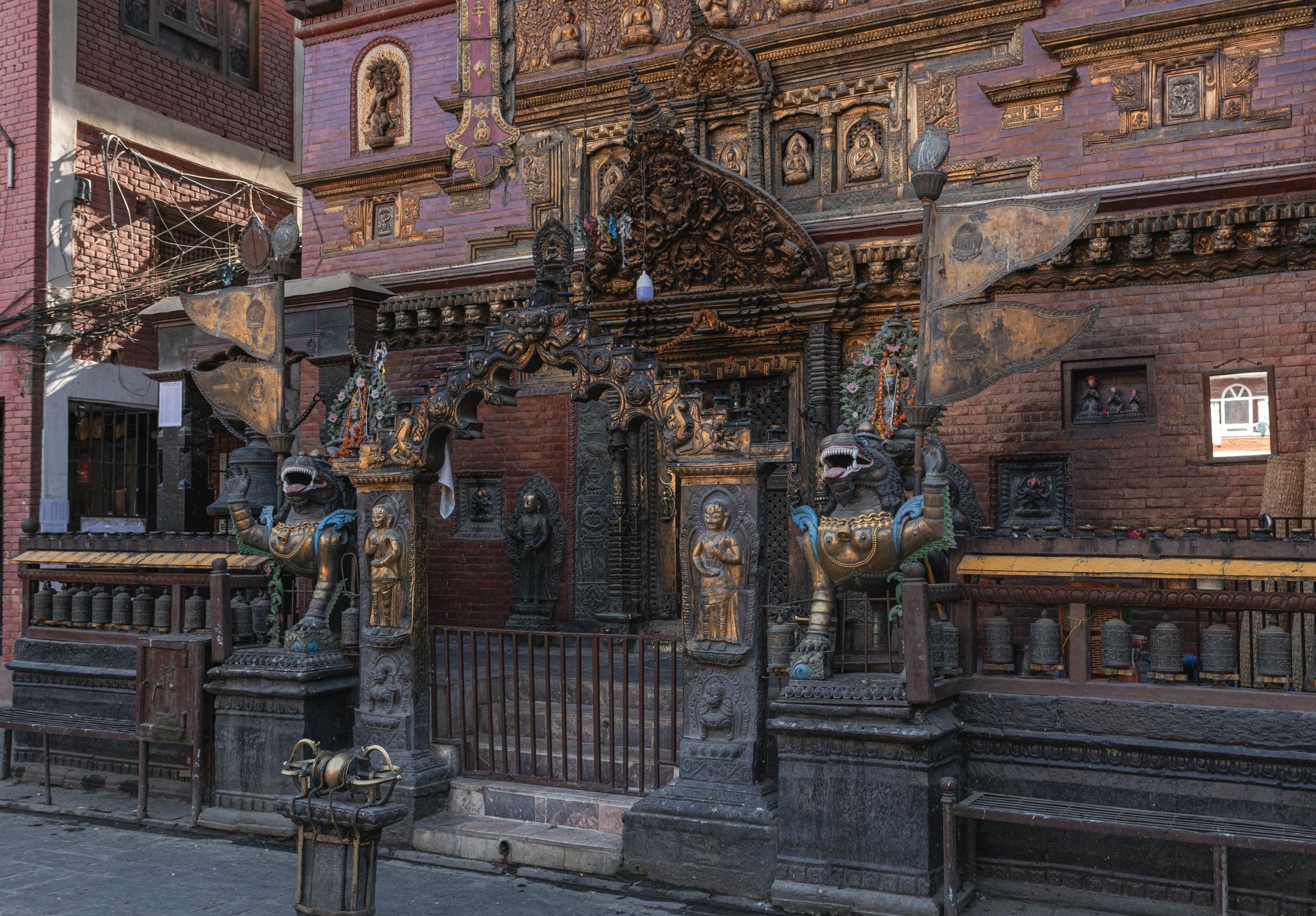 Intricate temple facade in Kathmandu, showcasing ornate carvings and statues.