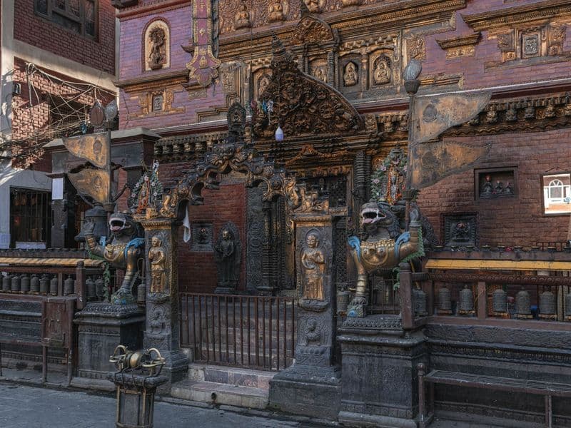 Intricate temple facade in Kathmandu, showcasing ornate carvings and statues.