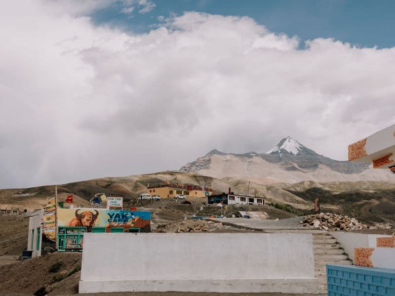 Explore the breathtaking terrain of Spiti Valley with snow-capped peaks and rustic architecture.