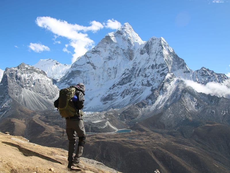 Backpacker exploring the stunning snow-capped mountains in Dingboche, Nepal.